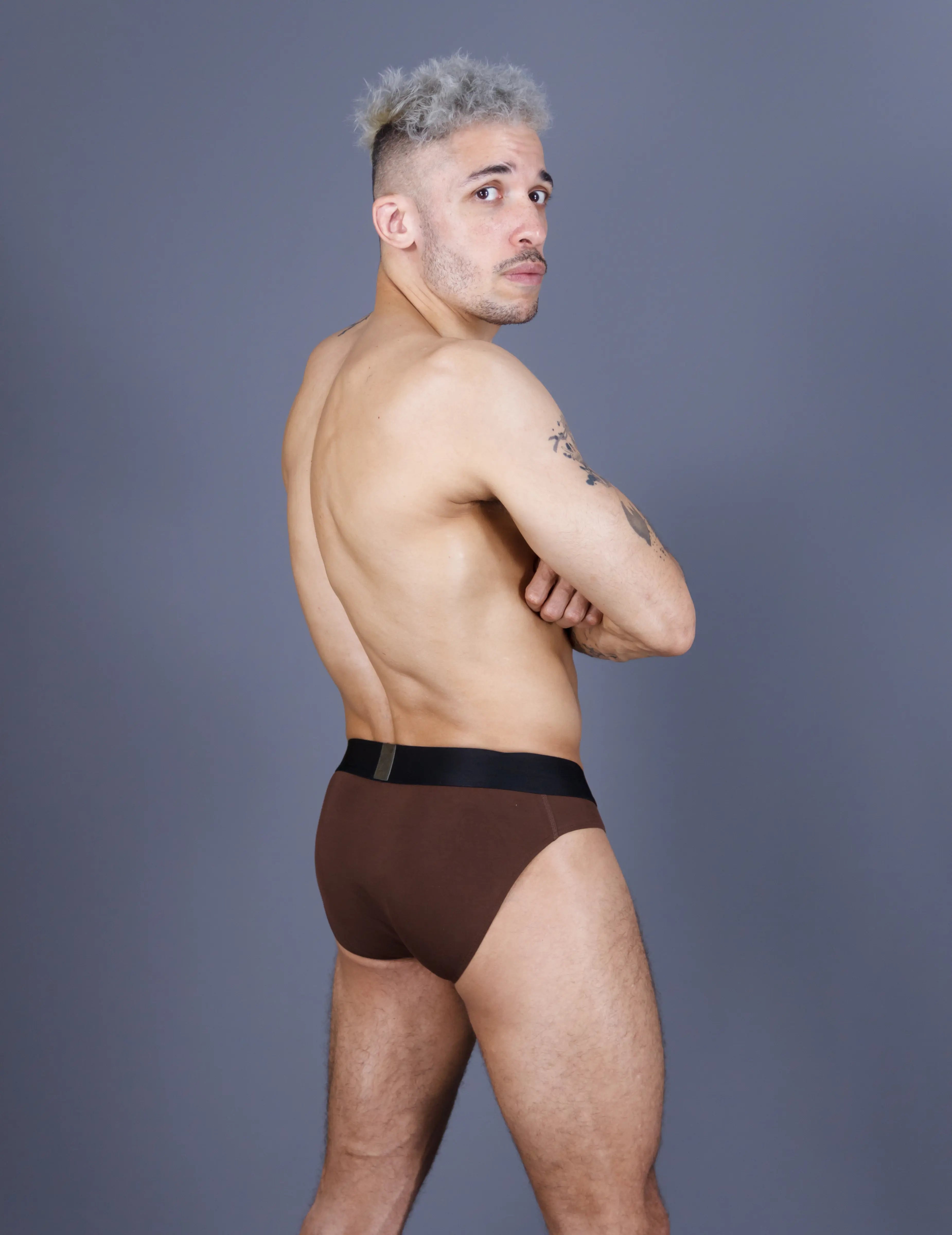 Man wearing brown briefs with big pouch back view