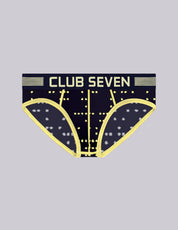 A pair of men's briefs with a large pouch, featuring a dark navy blue base with a yellow geometric star pattern and the brand name 'CLUB SEVEN' printed in yellow across the waistband.