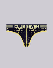 A pair of men's thong underwear with a big pouch, navy blue with a gold geometric star pattern and a wide waistband featuring the text 'CLUB SEVEN' in gold, shown on a solid light gray background.