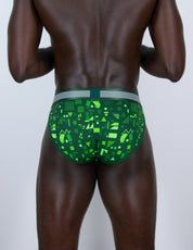 Rear view of a man wearing green patterned sports briefs with a grey and green waistband, shown against a plain light gray background.