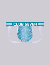 A novelty men's jockstrap with a big pouch, a teal waistband featuring the text 'CLUB SEVEN' in white, and a light blue patterned pouch, shown against a solid gray background. Designed in the UK